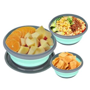 Drei faltbare Silikon-Schüsseln in verschiedenen Größen und Farben, ideal für Camping und Outdoor-Aktivitäten. Eine größere grüne Schale mit frischen Apfelstücken, eine zweite mit buntem Nudelsalat und eine kleinere mit knusprigen Snacks.
