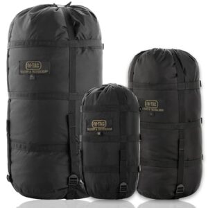 Drei runde, schwarze M-Tac Nylon Militär-Kompressionssäcke in gestapelter Anordnung, ideal für Reisen, Camping und Wandern, gefertigt aus strapazierfähigem und wetterfestem Nylonmaterial.