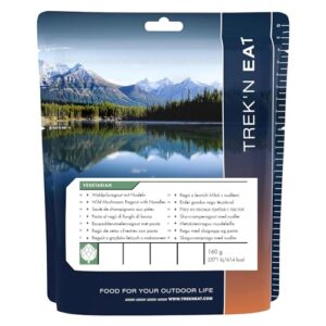 Verpackung von Trek'n Eat Waldpilzragout mit Nudeln in einer malerischen Naturumgebung. Ideal für Outdoor-Aktivitäten und als vegetarische Mahlzeit. Praktisches Design mit Nährwertinformationen.